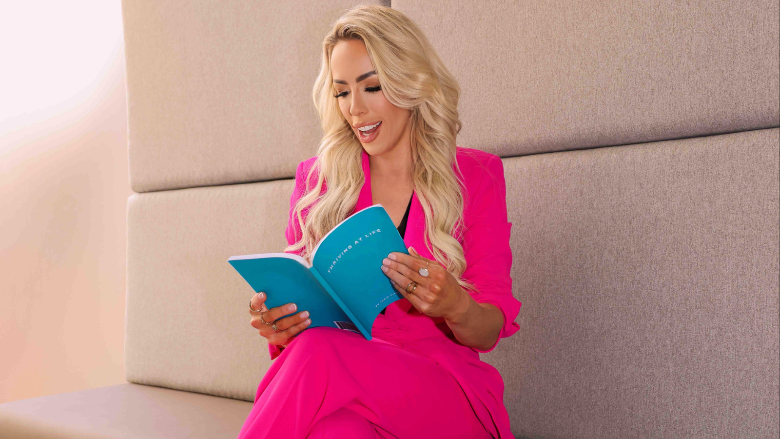 A person sat on a chair reading a journal