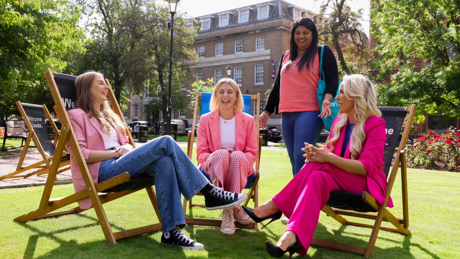 Four members of staff from Thrive Law, with three sat it big deck chairs.