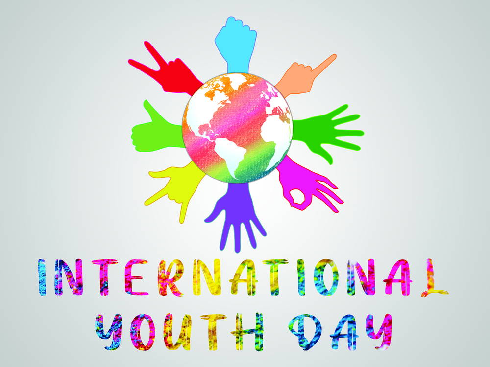 Colorful globe encircled by rainbow hands, symbolizing youth unity, with 'INTERNATIONAL YOUTH DAY' in rainbow letters below.